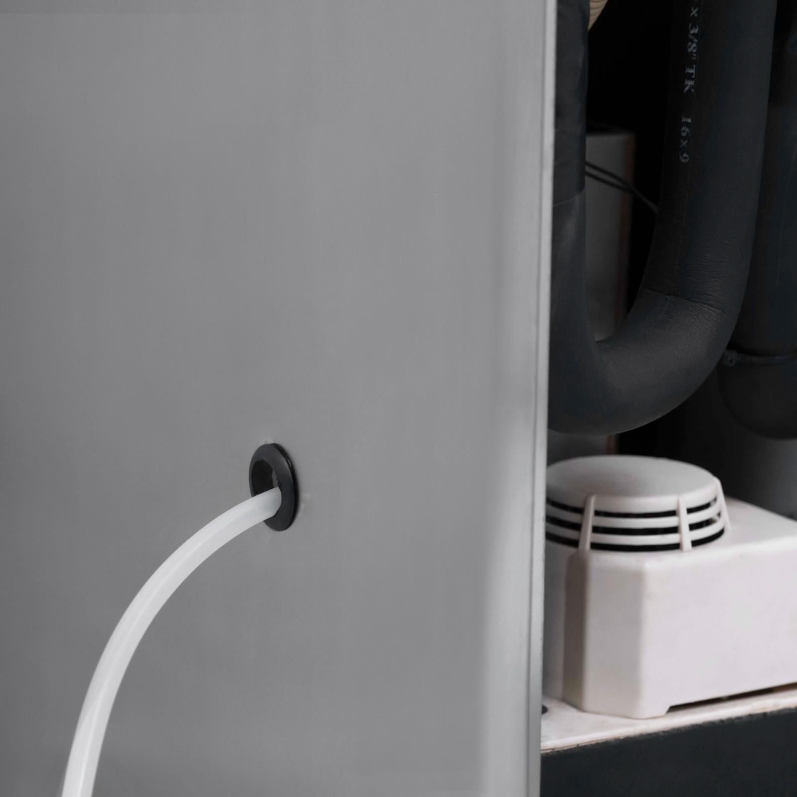 ALT Text: Close-up view of the White Westinghouse Industrial Dehumidifier WDE360S showing the drainage hose connected to the unit. Features include a durable metal body, efficient drainage system, and internal components designed for robust industrial use. Ideal for maintaining optimal humidity levels in large commercial spaces.