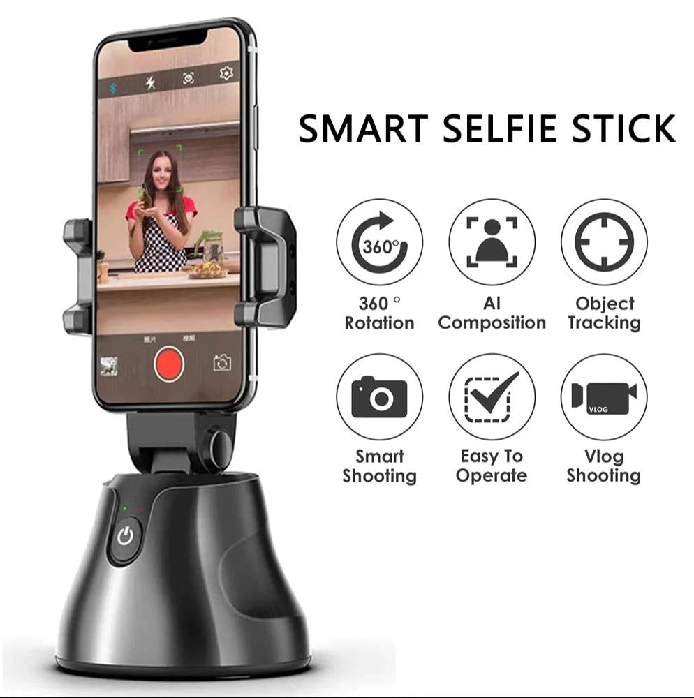 A smart selfie stick with a smartphone mounted on it, displaying a video recording of a person in a kitchen. The device has a sleek black base and supports 360-degree rotation.