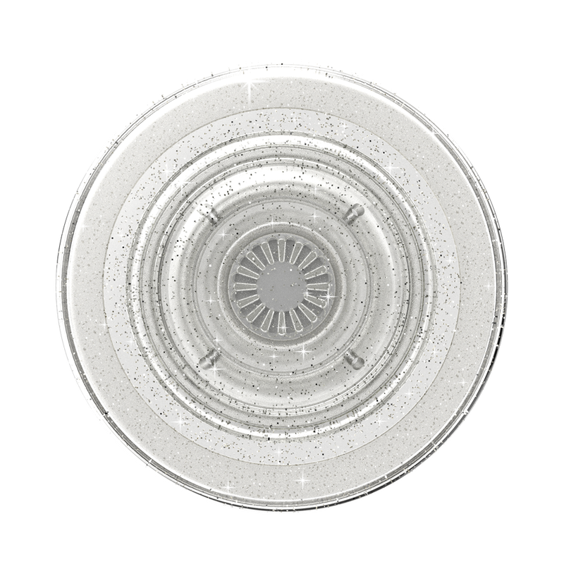 A close-up view of a PopSockets Clear Glitter PopGrip for MagSafe is shown. The grip features a round, flat surface with a clear, glittery finish. The transparent design with embedded glitter particles creates a sparkling effect. The central part of the PopGrip has a detailed pattern, and the overall design emphasizes its elegant and stylish appearance while being compatible with MagSafe technology.
