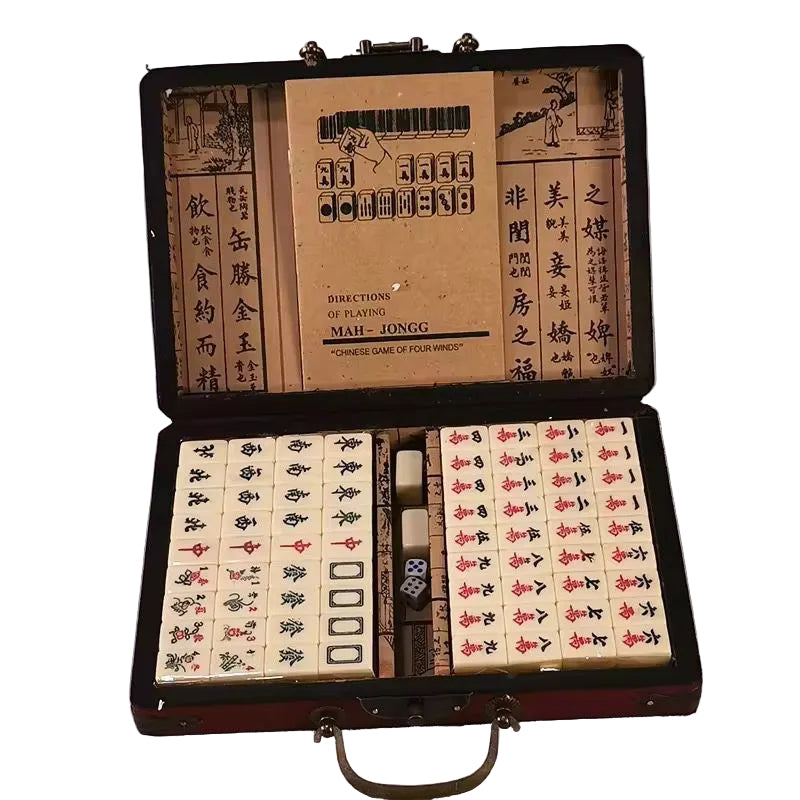Open mahjong set with tiles and instructions on a white background
