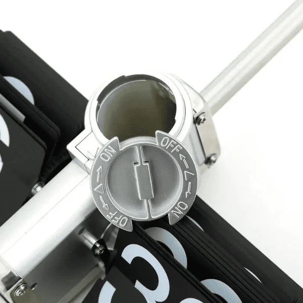 : A close-up view of the top mechanism of a vintage-style flip clock. The image shows the cylindrical part with an "ON" and "OFF" switch clearly marked, which is used to control the clock's operation. The black and white flip cards of the clock are visible around the mechanism, highlighting the clock's functional components.