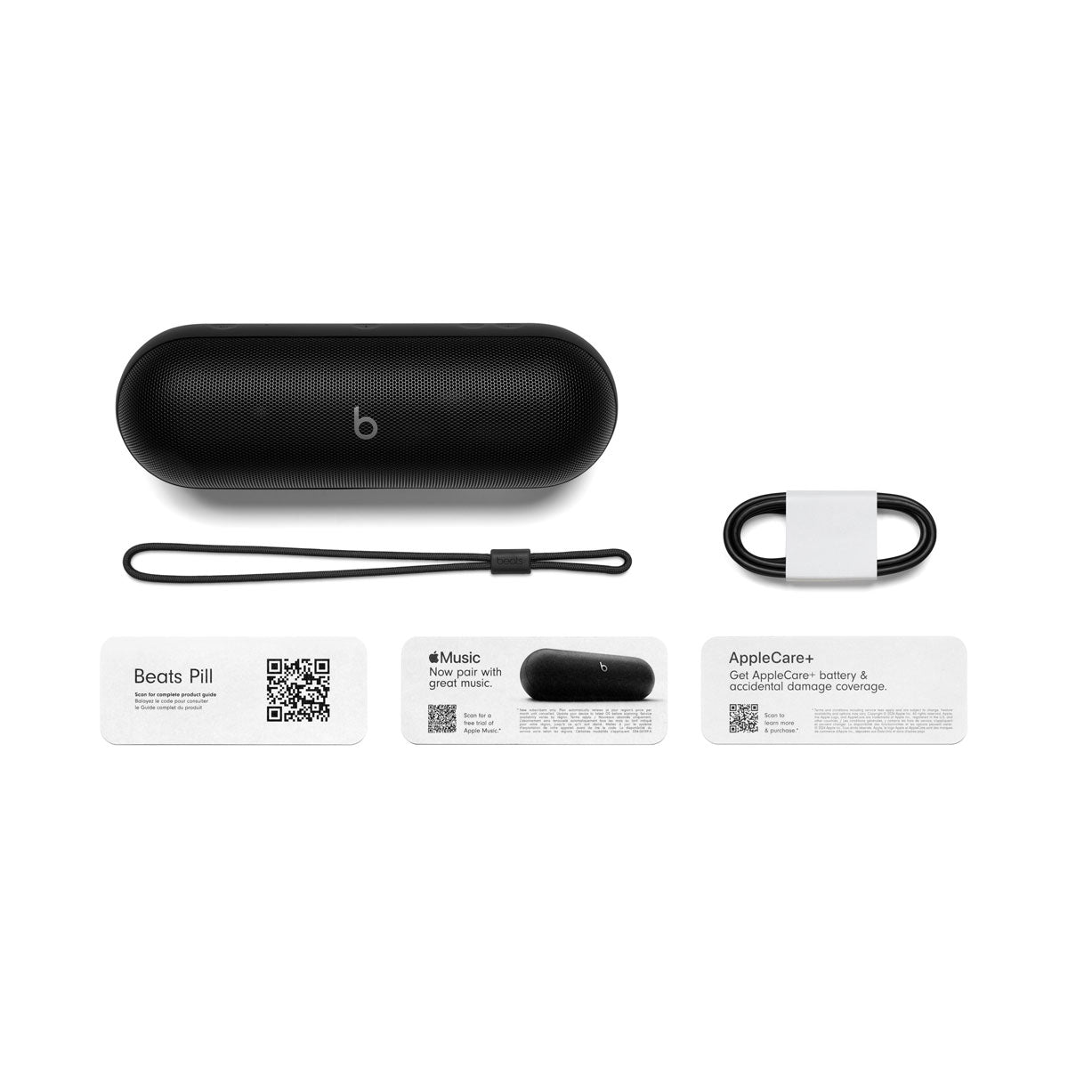 Alt text for this image:
Black Beats portable speaker displayed with included accessories: a lanyard, charging cable, and product information cards for Beats Pill, Apple Music, and AppleCare+. The setup emphasizes the full contents provided with the speaker.