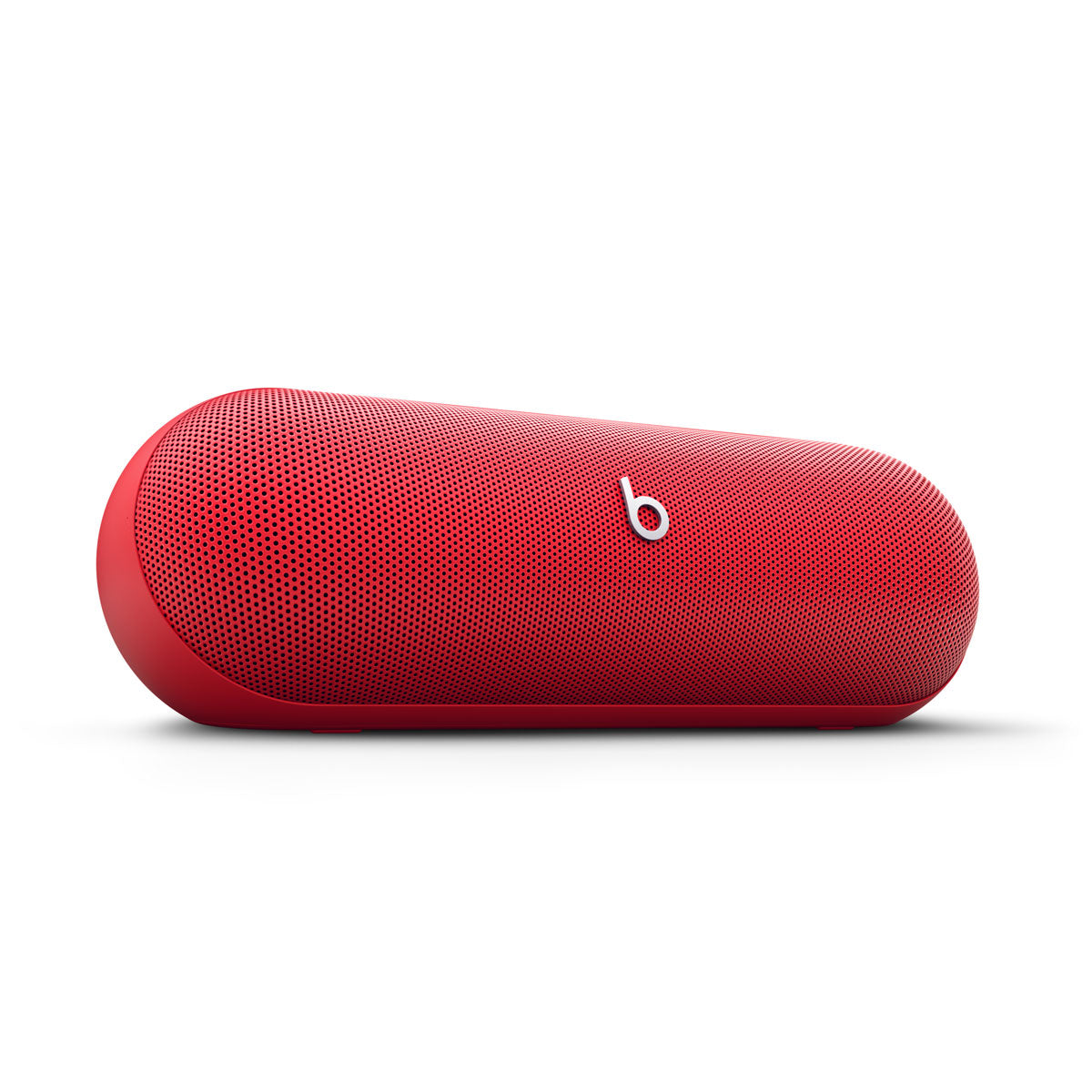 Alt text for this image:
A close-up view of a red Beats portable speaker, showcasing its sleek and minimalist design with the iconic Beats logo in the center.