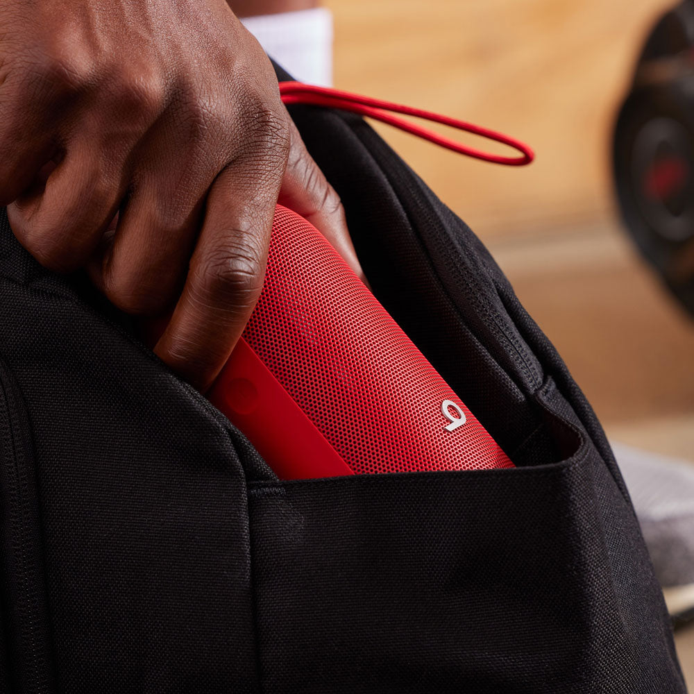 A person placing a red Beats portable speaker into a black backpack pocket, emphasizing the compact and portable design ideal for on-the-go use.
A person placing a red Beats portable speaker into a black backpack pocket, emphasizing the compact and portable design ideal for on-the-go use.
A person placing a red Beats portable speaker into a black backpack pocket, emphasizing the compact and portable design ideal for on-the-go use.
