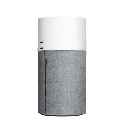 Sleek cylindrical air purifier with a white top and grey fabric lower half, featuring a side zipper for filter access and minimalistic control buttons for easy operation.