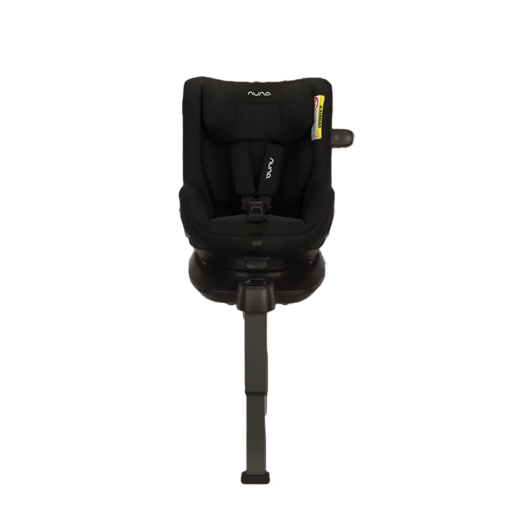 Slightly angled front view of a Nuna convertible car seat in black, equipped with a five-point harness and adjustable support leg, securely mounted on an ISOFIX base.