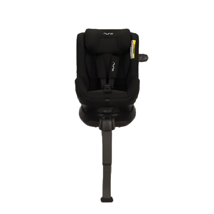 Front view of a Nuna convertible car seat in black, featuring a five-point harness, padded headrest, and support leg, mounted on an ISOFIX base for secure vehicle installation.