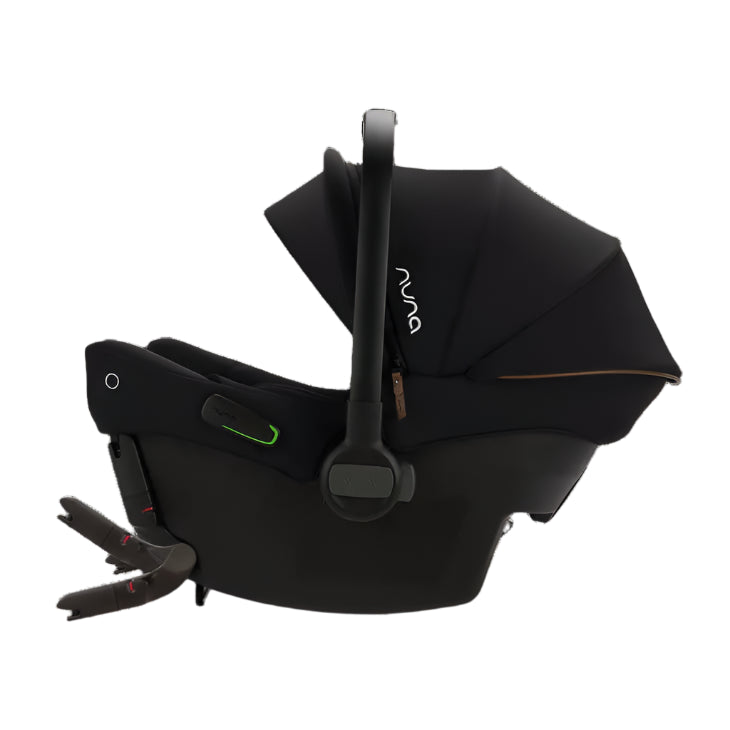 Side view of a black Nuna infant car seat featuring an extended canopy, a leatherette carry handle, green installation indicators, and visible ISOFIX connectors.