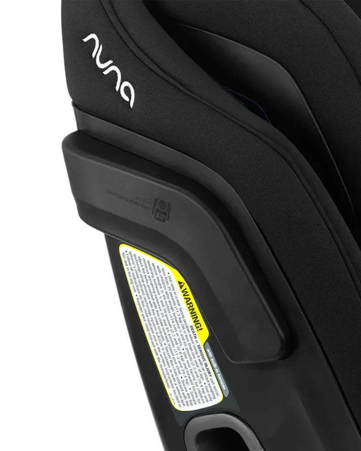 Close-up of a Nuna car seat showcasing the side impact protection pod and warning label, emphasizing safety features built into the seat’s side structure.