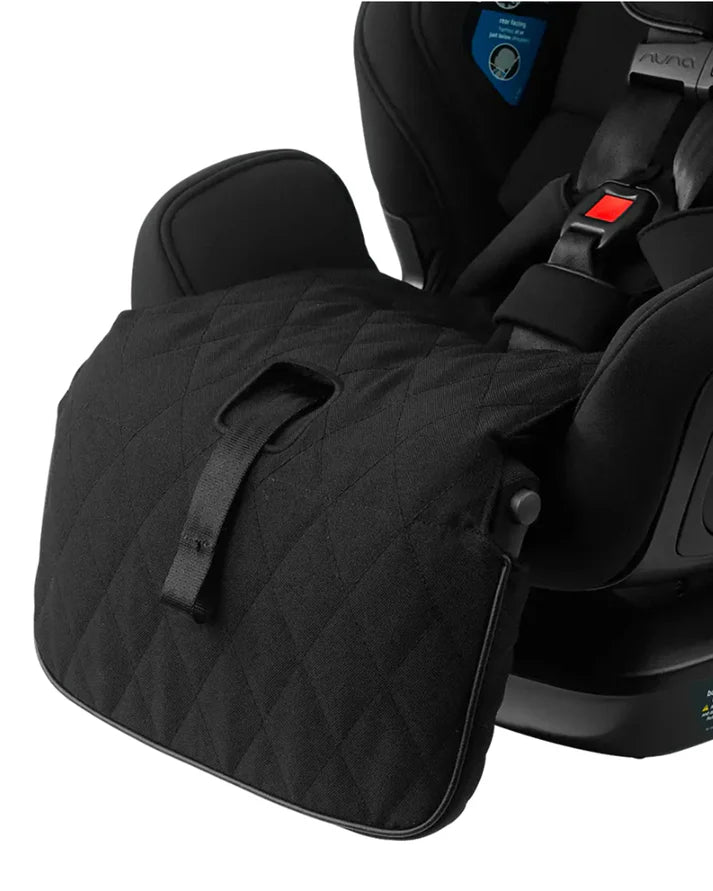 A padded footrest cover is attached to the front of a child car seat for added comfort and protection.