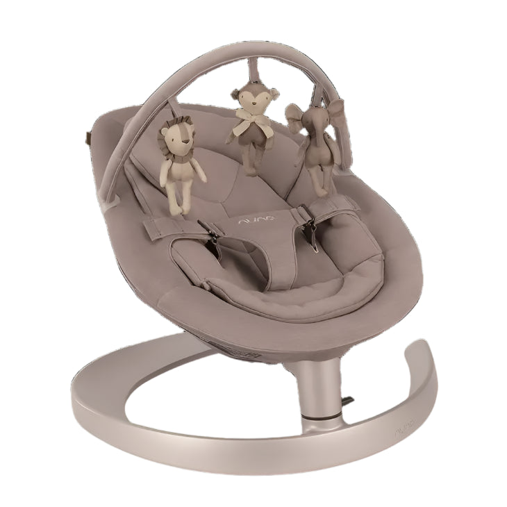 A taupe-colored baby rocker with a sleek curved base, featuring a toy bar with three plush animal toys—a lion, monkey, and elephant—for visual stimulation.