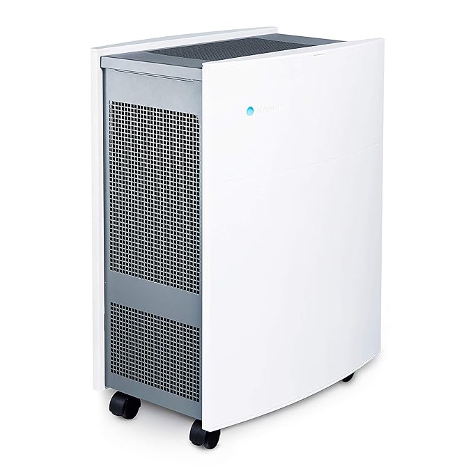 Angled view of a Blueair air purifier featuring a sleek white curved front panel, side air intake vents, and caster wheels for easy mobility.