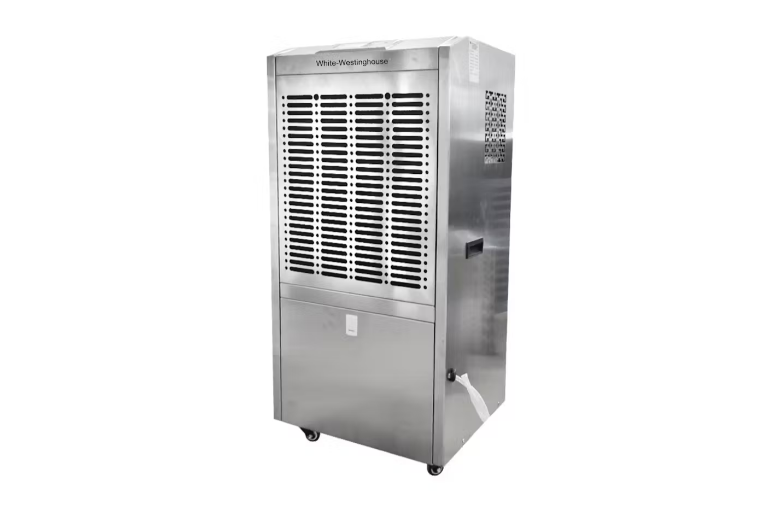 A large White-Westinghouse industrial dehumidifier with a metallic silver exterior. The top section features a grid of black ventilation slots, while the bottom section has a solid panel