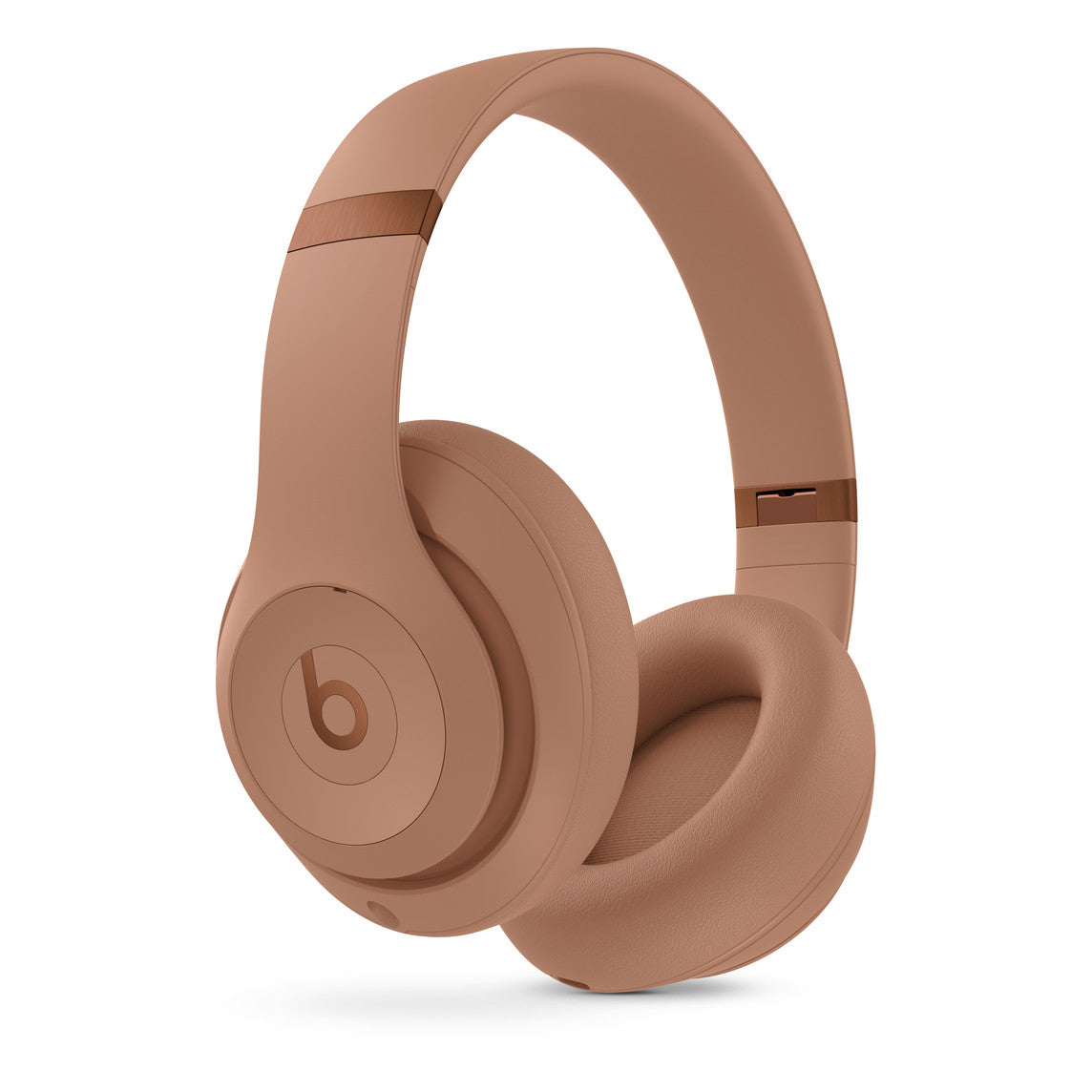 Light brown over-ear wireless headphones with a sleek, minimalist design, featuring a prominent b logo on the ear cups, cushioned ear pads, and an adjustable headband for optimal comfort.