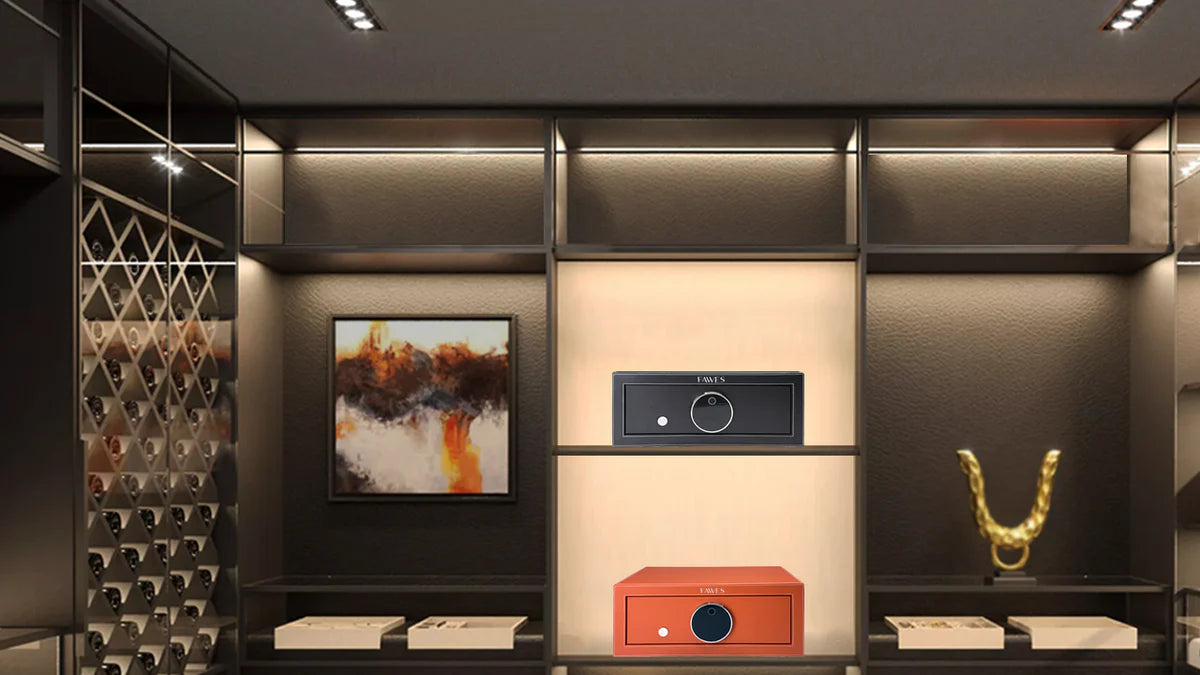 Luxury showroom interior featuring two FAWES safes displayed in a well-lit central shelf — one in black and the other in tan leather finish. The room has a modern aesthetic with dark tones, ambient lighting, wine racks, abstract artwork, and decorative elements.