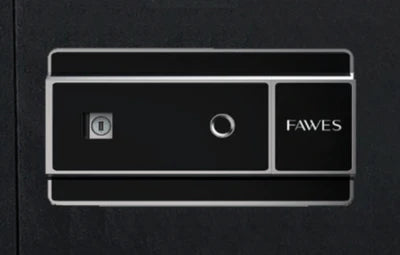 Close-up view of a digital keypad on a safe. The keypad has a sleek black design with metallic accents. On the left side, there is a key slot, and on the right side, the word "FAWES" is printed. The overall design emphasizes modernity and security.