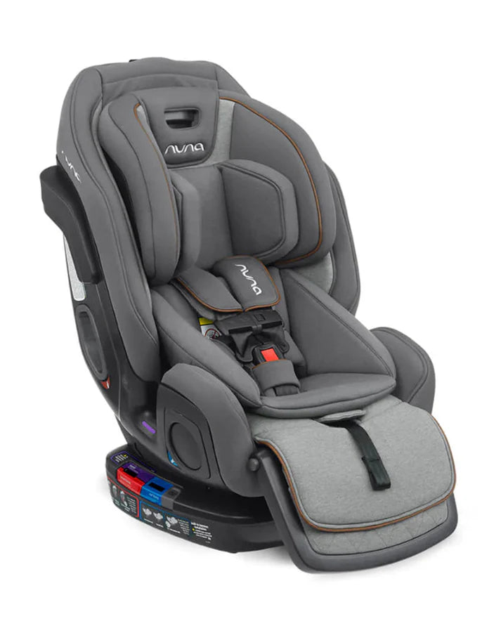 A sleek grey Nuna convertible car seat is shown with a padded insert, adjustable harness, recline options, and an attached leg rest for enhanced child comfort and safety.