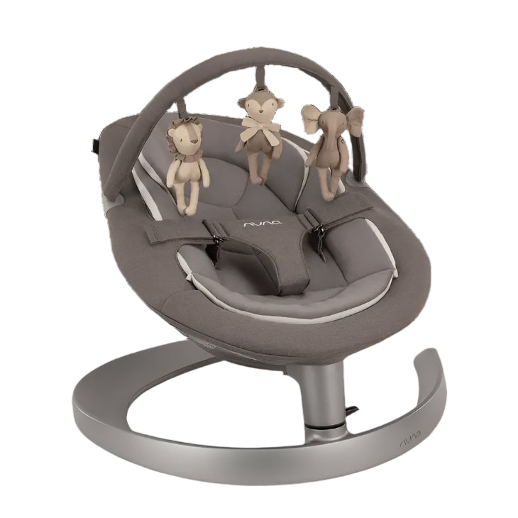 Grey baby rocker with a cushioned seat, adjustable harness, and a toy bar featuring three plush animal toys (lion, monkey, elephant) hanging overhead, mounted on a sleek metallic curved base.