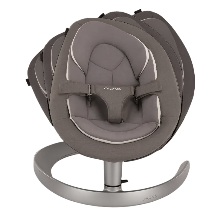 Front view of a modern baby rocker in grey with multiple swing positions shown in a layered motion effect, featuring a padded seat with harness and a sleek silver curved base.
