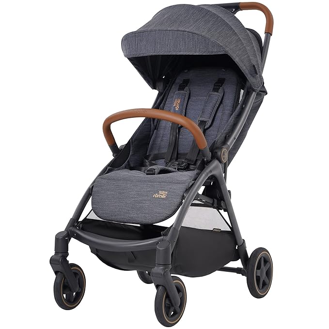 A stylish dark grey baby stroller with brown leatherette bumper bar, adjustable canopy, padded seat with safety harness, and four wheels with a storage basket underneath.