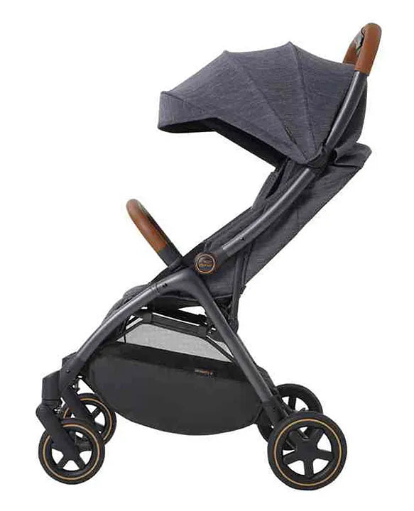 Side view of a sleek dark grey baby stroller with a curved canopy, brown leatherette accents on the handle and safety bar, and a spacious black storage basket at the bottom.