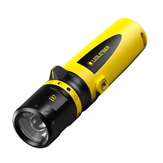 The LEDLenser EX7 flashlight, shown at an angle with its distinctive yellow and black color scheme. The flashlight has a sturdy build, with a prominent lens at the front and the LEDLenser logo visible along the side. The flashlight's design includes a textured grip and control buttons near the top.
