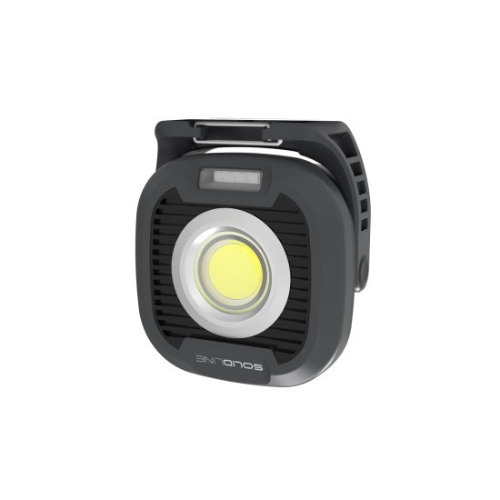 A compact, square-shaped black and gray LED work light from SOLIDline. It features a large, circular LED in the center, surrounded by a ridged design for heat dissipation. The light has a sturdy base with a clip at the top for attaching or securing the light. The word "SOLIDline" is printed on the bottom edge of the light.