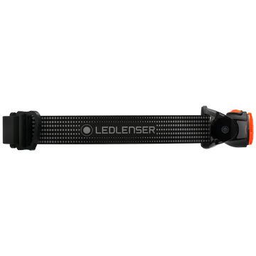 A black LED Lenser headlamp strap is shown from the side, displaying the "LED LENSER" branding in the center. The strap is adjustable and designed to provide a secure fit for the headlamp. The ends of the strap feature attachment points for the headlamp unit, with a small portion of an orange component visible on the right side. The strap has a dotted pattern for added grip and comfort.