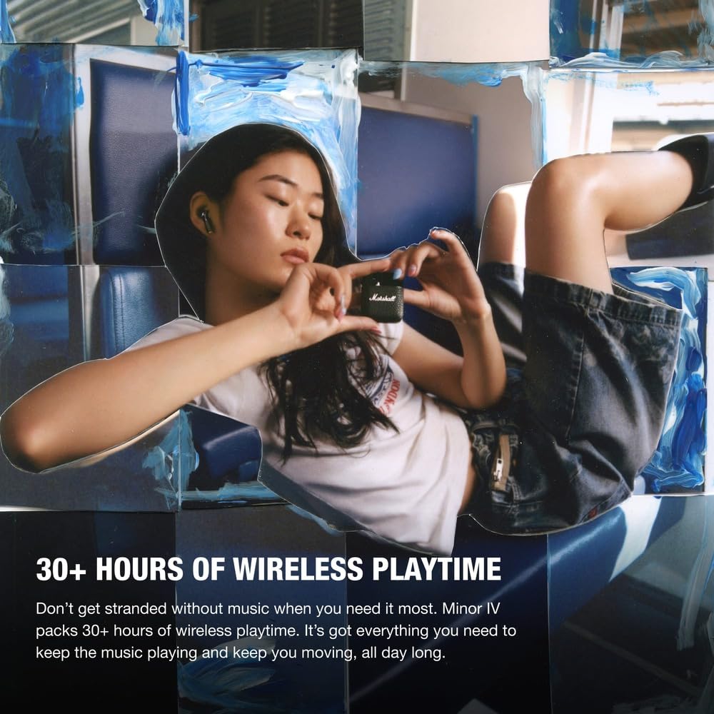 A promotional image featuring a woman reclining on a blue seat, wearing Marshall Minor IV wireless earbuds and holding their black textured charging case with the iconic Marshall logo. The setting appears to be inside public transport or a lounge area. The text highlights the earbuds' impressive battery life, stating "30+ HOURS OF WIRELESS PLAYTIME," ensuring uninterrupted music throughout the day. The advertisement emphasizes the earbuds' convenience and reliability for users on the go.