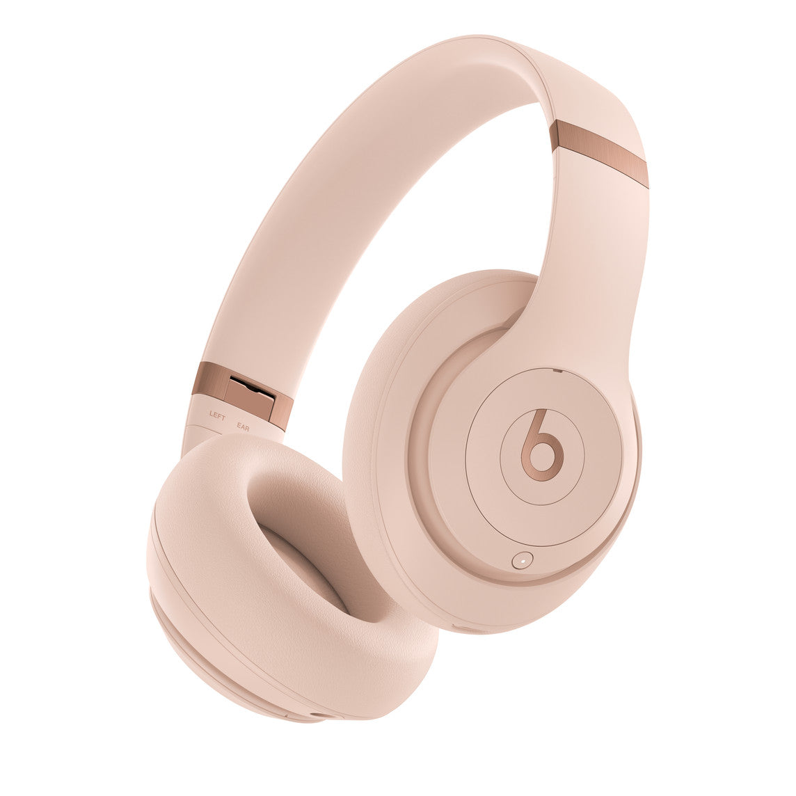 A pair of over-ear headphones in a soft pink color, featuring a prominent "b" logo on the earcup and rose gold accents on the headband hinge, designed for a sleek and modern look.
