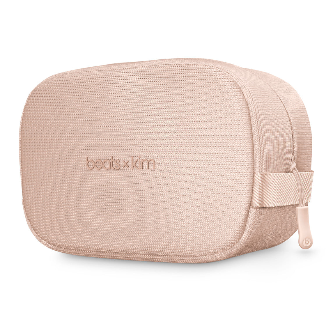 A soft pink rectangular carrying case labeled "beats x kim," featuring a textured fabric exterior and a zipper closure, designed for stylish storage and portability.