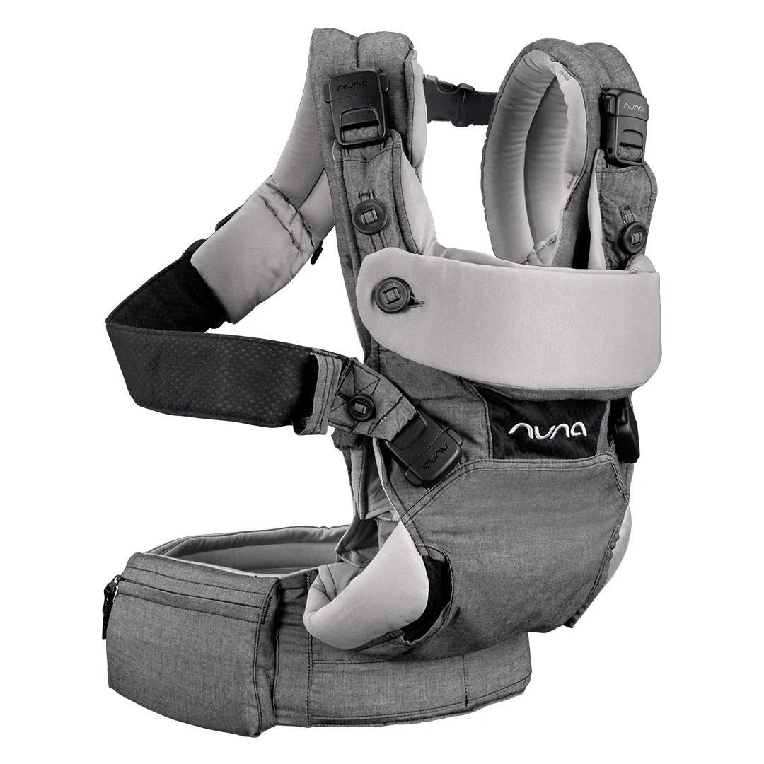 This is a Nuna baby carrier in grey featuring cushioned shoulder straps, a supportive waist belt with zippered pocket, and ergonomic seat and back support for comfortable babywearing.