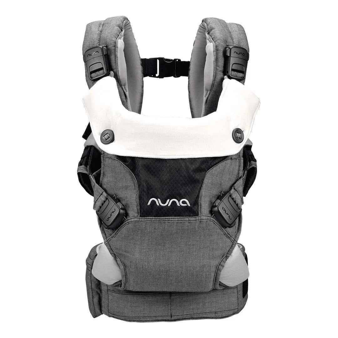 This is a Nuna baby carrier featuring padded shoulder straps, a white organic cotton bib, multiple safety buckles, and a supportive design for ergonomic babywearing.