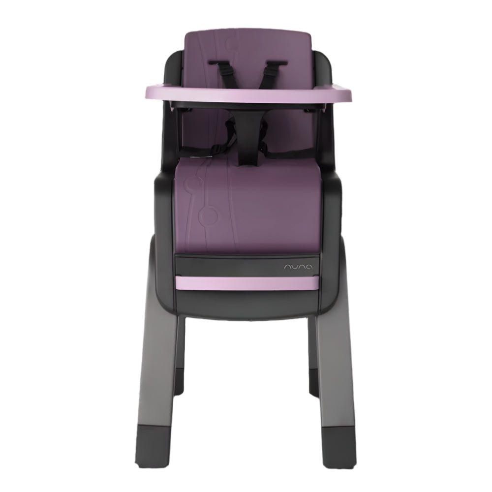 Front view of a Nuna high chair in a purple and grey color combination, featuring a five-point harness, matching tray, and footrest for secure and stylish toddler seating.