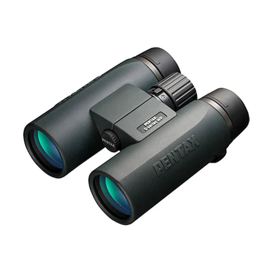 A pair of Pentax SD 10x42 ED binoculars with a sleek, ergonomic design. The binoculars feature large objective lenses with a greenish tint and a durable body with a matte finish. The Pentax branding is prominently displayed on the side of the right barrel. The central focusing wheel is positioned between the two barrels for easy adjustment. The binoculars are designed for a comfortable grip and handling, emphasizing high-quality optics and durability.