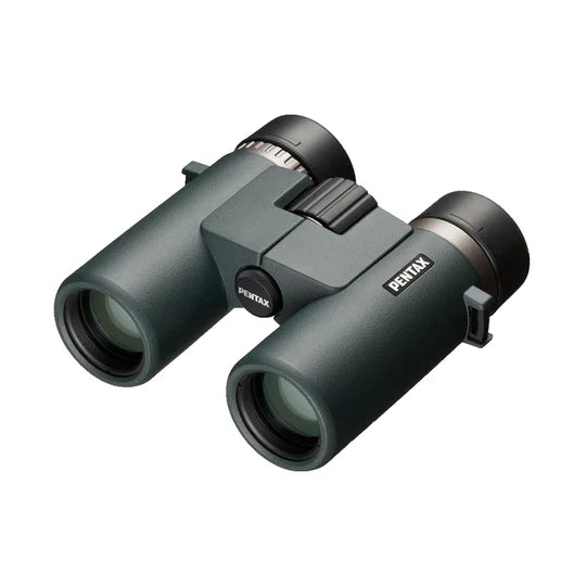 A pair of Ricoh Pentax AD 10x32 ED binoculars with a compact and ergonomic design. The binoculars feature large objective lenses with a greenish tint and a durable body with a matte finish. The Pentax branding is prominently displayed on the side of the left barrel. The central focusing wheel is positioned between the two barrels for easy adjustment. The binoculars are designed for a comfortable grip and handling, emphasizing high-quality optics and portability.