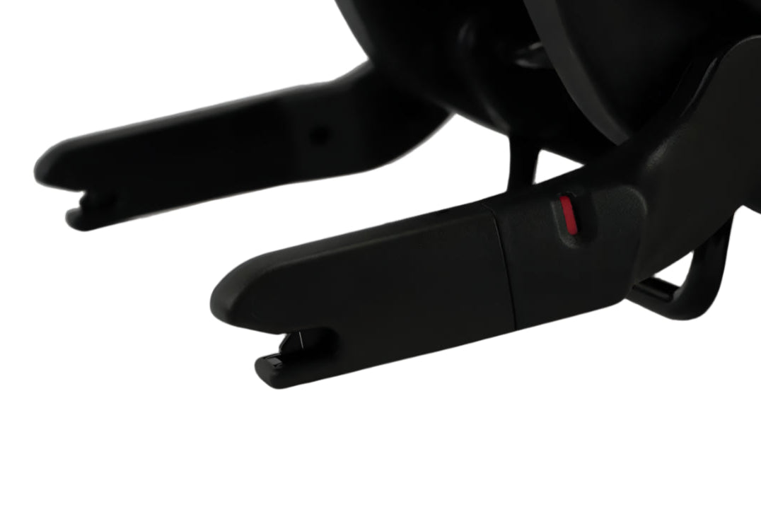 Close-up view of a black Nuna car seat base latch connectors, showing the red safety indicator and the attachment hooks designed to secure the base to a vehicle’s ISOFIX/LATCH system.