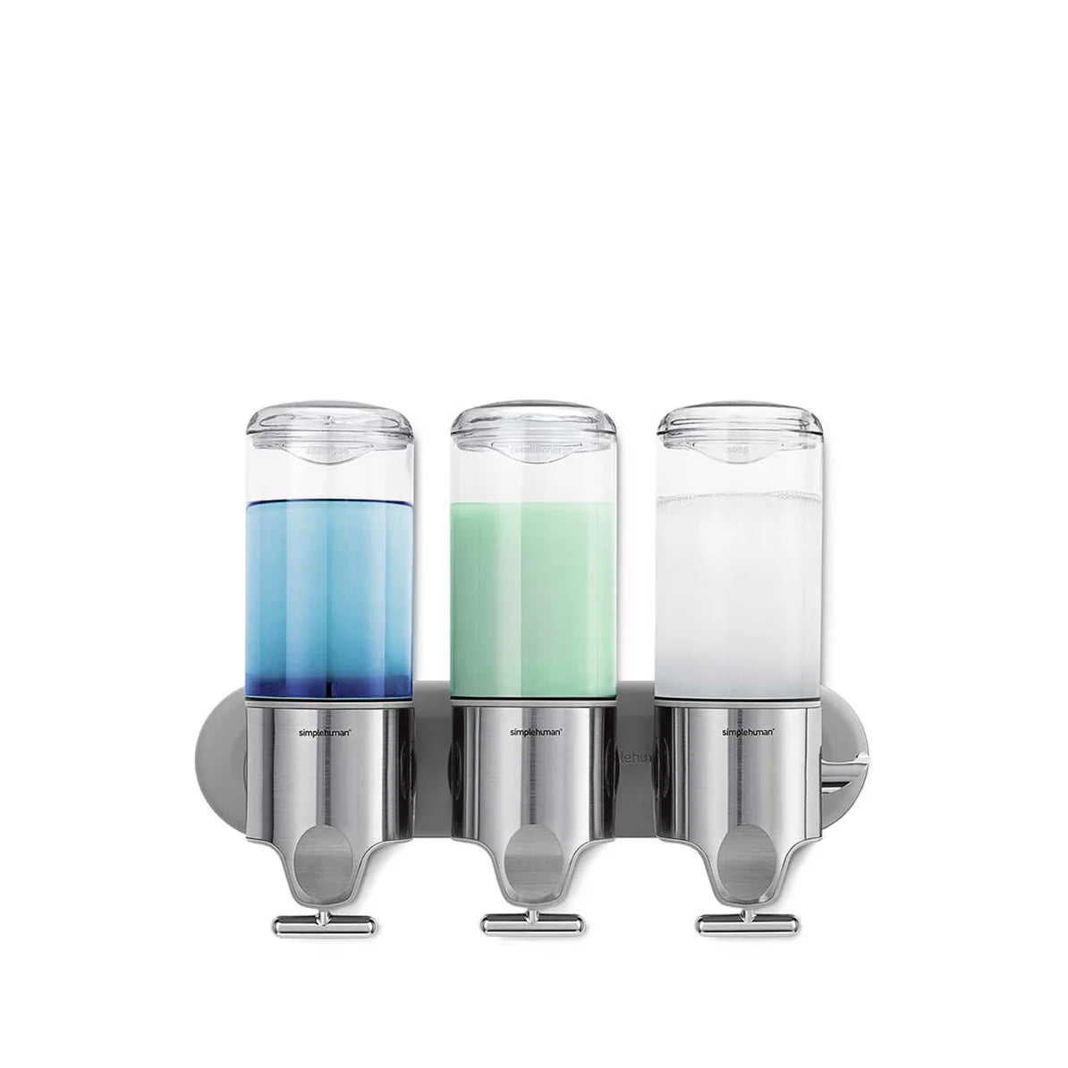 The image features a wall-mounted triple dispenser system, likely designed for bathroom use to hold liquids such as shampoo, conditioner, and body wash. The dispensers are made of stainless steel and clear plastic, giving them a modern and sleek appearance. Each dispenser contains a different colored liquid: one is filled with blue liquid, another with green, and the third with white. The dispensers are aligned horizontally and mounted on a stainless steel backplate, making them easy to access and use. The
