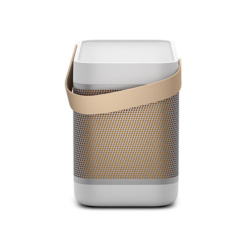 This image showcases a **Bang & Olufsen (B&O) portable speaker** in a **light grey and beige color scheme**. The speaker is designed with a **cylindrical shape** and features a **beige leather strap** for easy portability. The **beige perforated grille** covers the speaker body, emphasizing a sleek and minimalist design. This compact and elegant speaker integrates **high-quality materials** with functional design, typical of B&O's luxury audio products, making it perfect for both home and on-the-go use.
