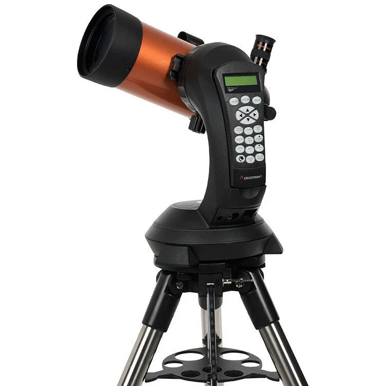 A Celestron NexStar 4SE telescope with an orange cylindrical tube mounted on a black computerized base and a silver tripod. The telescope is angled slightly upward for observation. The base features a control panel with a keypad and a small display screen for navigation and settings.