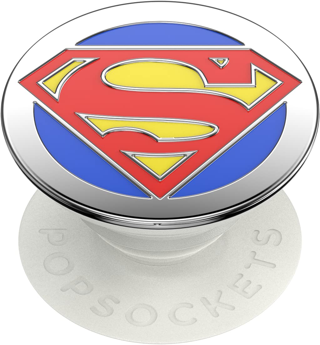  A PopSockets Enamel Swappable Grip featuring the Superman logo. The grip has a circular top with the iconic Superman "S" shield in red and yellow on a blue background. The base is white with "PopSockets" embossed around the edge. This design provides both a stylish and functional accessory for holding and supporting a smartphone, with the added feature of being swappable for different designs.