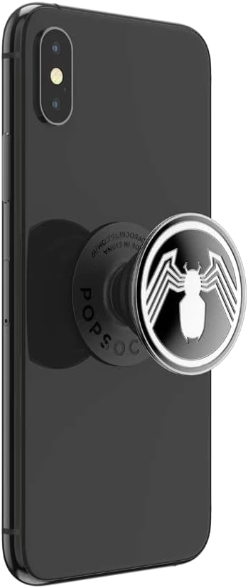 Black smartphone with a Marvel Enamel Spider-Man PopGrip attached to the back. The PopGrip features a black and white Spider-Man emblem with a stylized white spider on a black background. The phone is shown from the back at a slight angle, with the PopGrip extended outward.