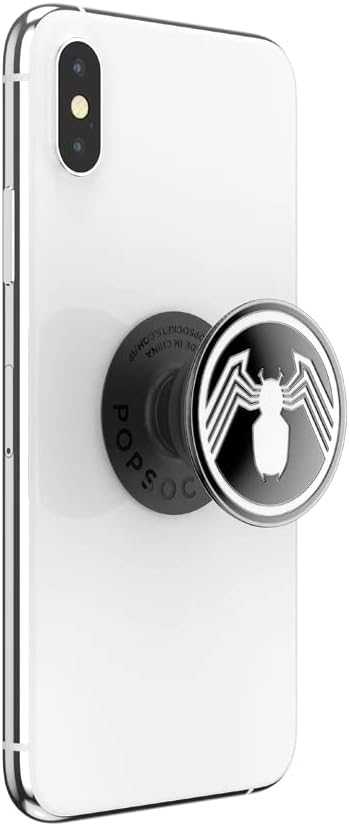 White smartphone with a Marvel Enamel Spider-Man PopGrip attached to the back. The PopGrip features a black and white Spider-Man emblem with a stylized white spider on a black background. The phone is shown from the back at a slight angle, with the PopGrip extended outward.