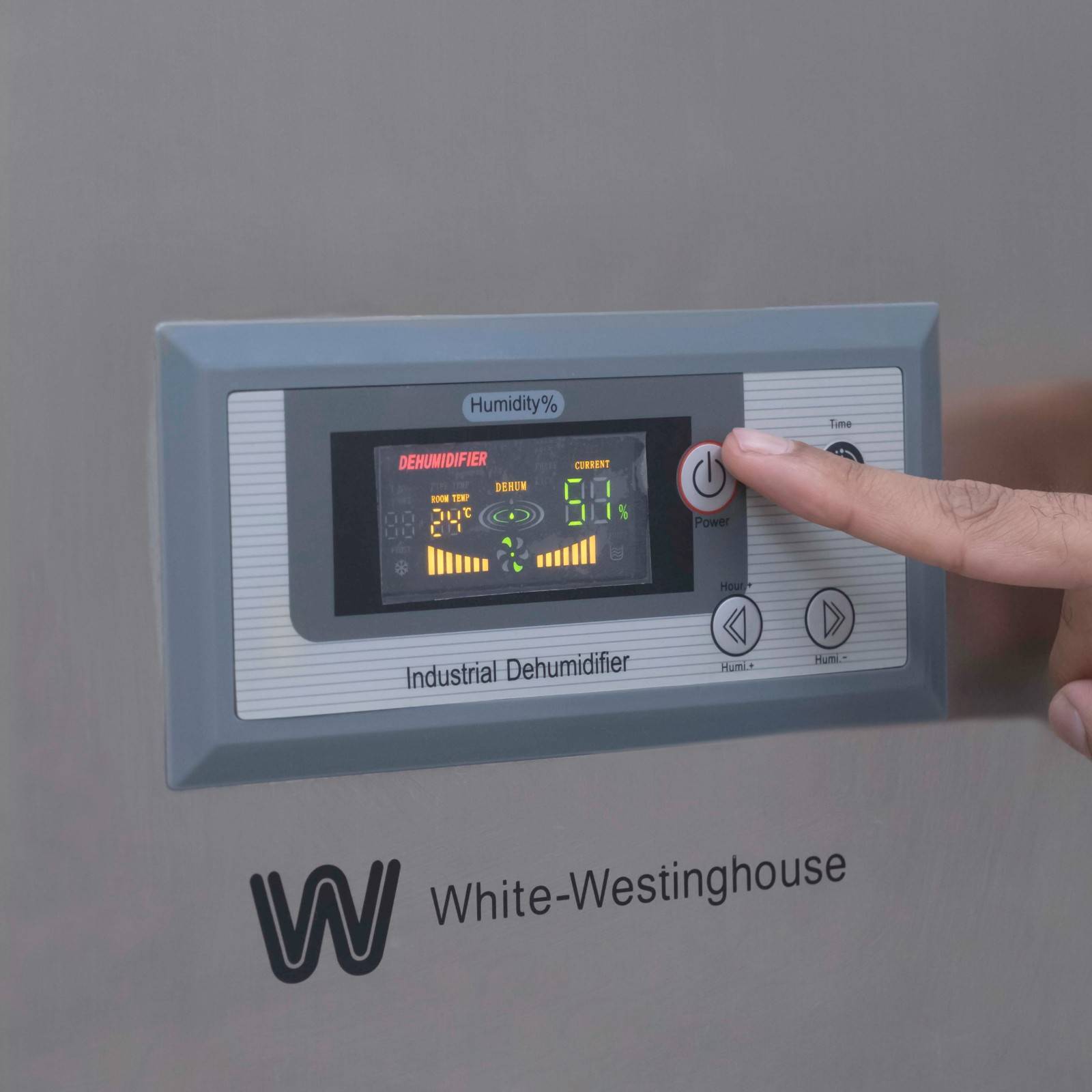Close-up view of the digital control panel on the White Westinghouse Industrial Dehumidifier WDE168S, with a person's finger pressing the power button. The display shows various settings and indicators for humidity control, ensuring easy operation and precise adjustments. Ideal for maintaining optimal humidity levels in large commercial and industrial spaces.