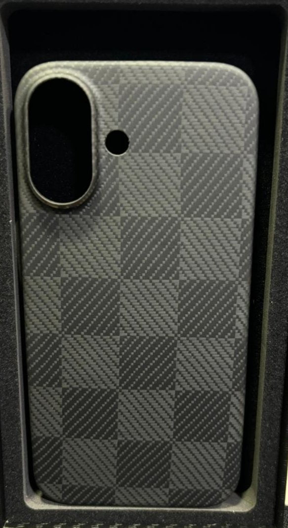 This image depicts a smartphone case with a carbon fiber-like checkerboard texture. It features cutouts for a single camera and an additional hole, likely for a flash or microphone. The design is minimalist, with no visible branding or markings, suggesting a focus on a clean, streamlined look that enhances the style of the phone while providing protection. The texture adds a sleek and modern aesthetic, making it an appealing choice for those who prefer subtle yet stylish phone accessories.