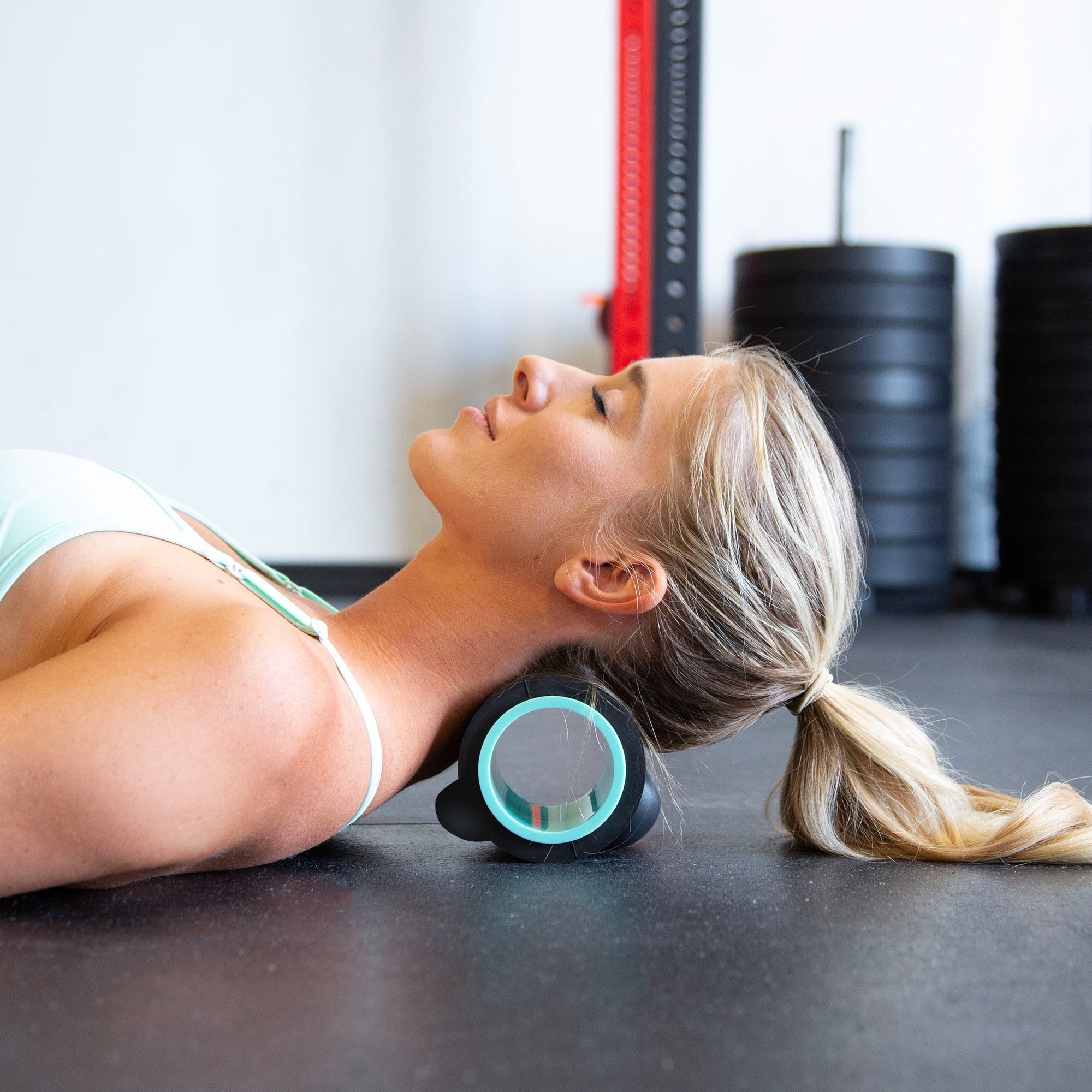 Person lying back with the Chirp Wheel XR 4 inch under the base of the skull