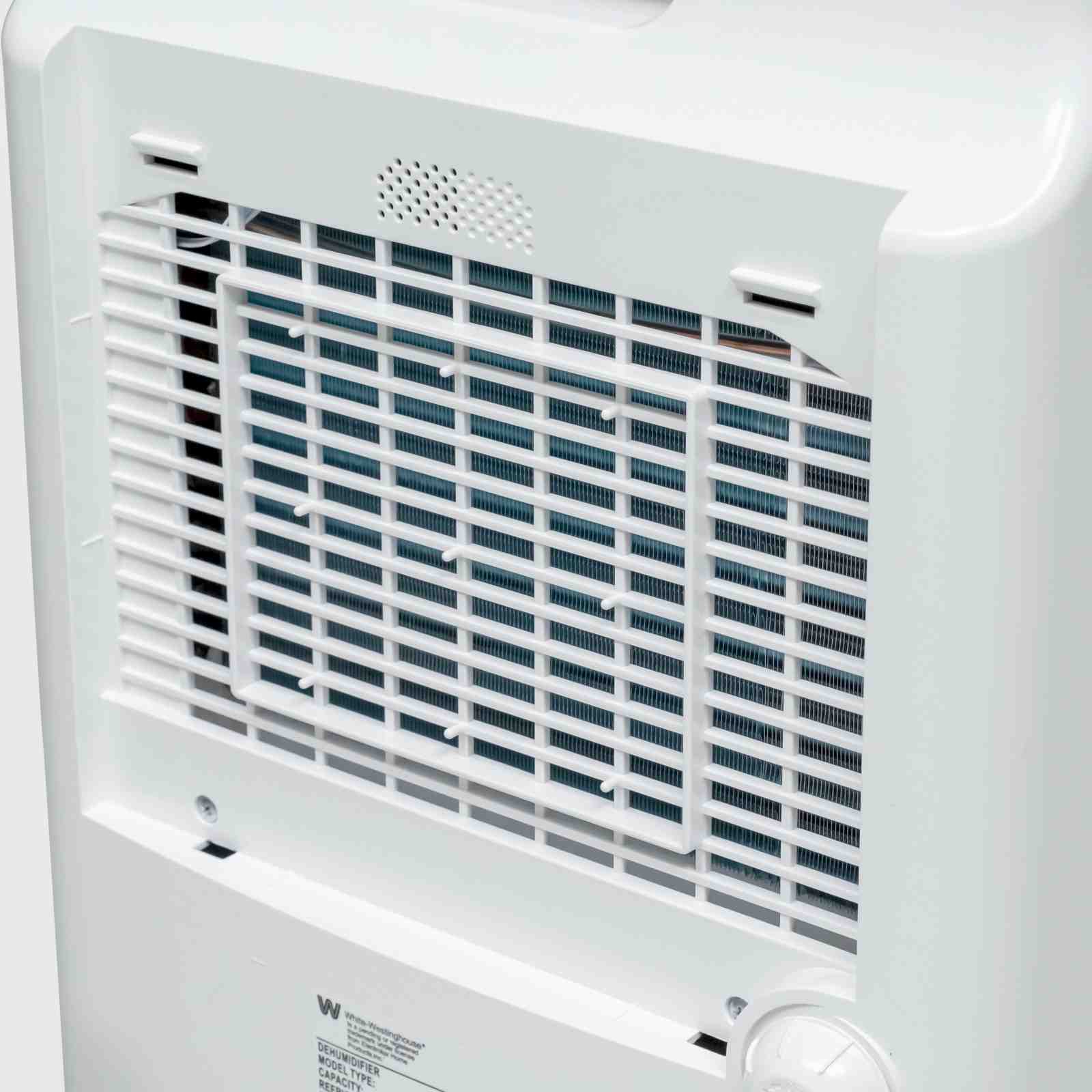 Close-up view of the rear vent and air filter on the White Westinghouse Dehumidifier AWHD20L, showcasing the efficient airflow design. The white body includes labels with safety and operational information, suitable for maintaining optimal humidity levels in residential and commercial spaces.