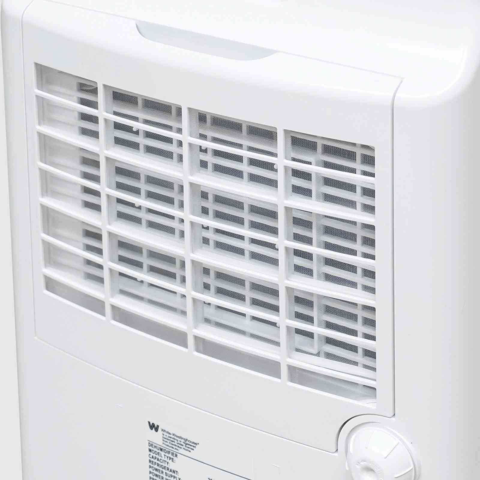 Close-up view of the rear vent and control knob on the White Westinghouse Dehumidifier AWHD20L, highlighting the efficient airflow design. The white body includes labels with safety and operational information, suitable for maintaining optimal humidity levels in residential and commercial spaces.