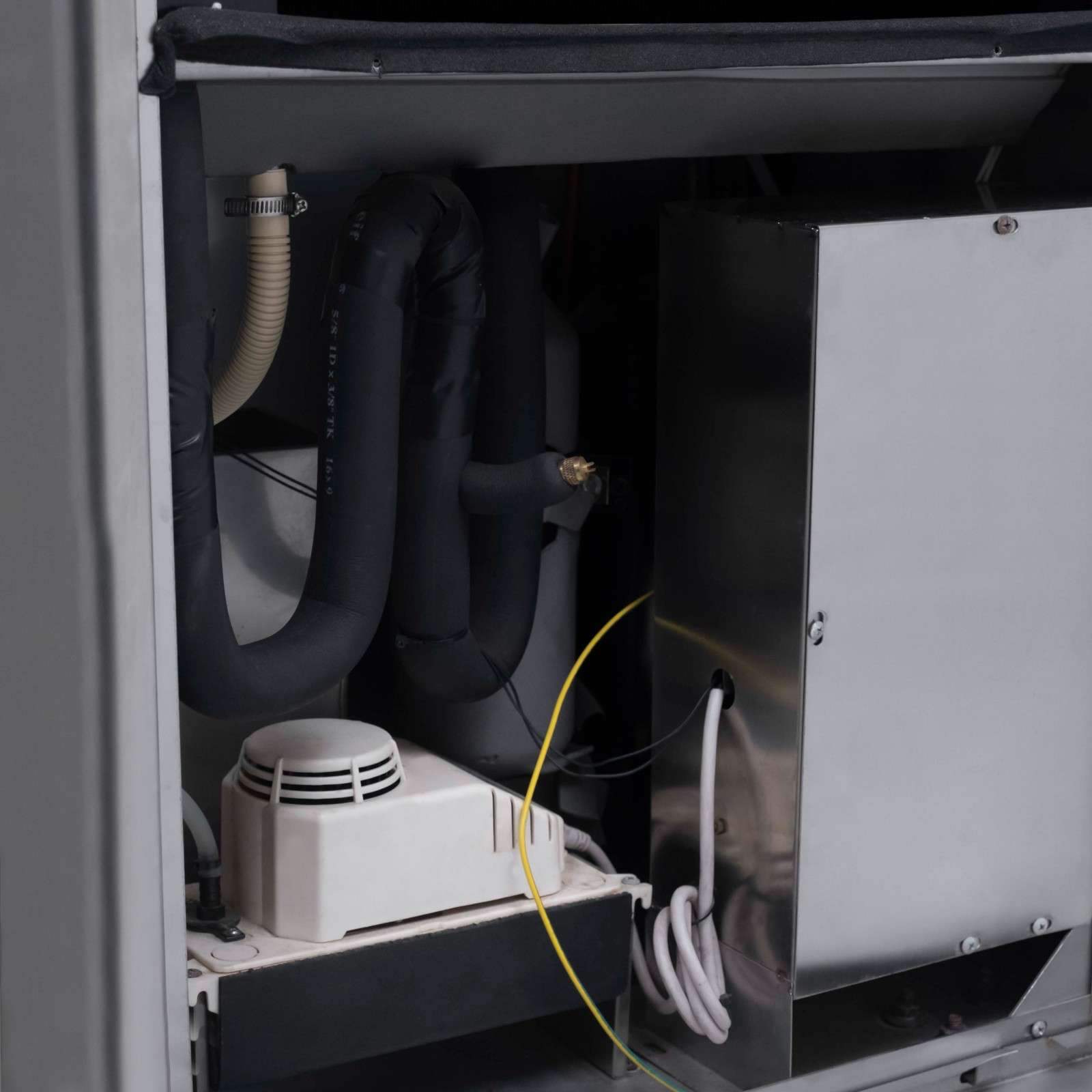 Close-up view of the internal components of the White Westinghouse Industrial Dehumidifier WDE360S, showcasing the detailed internal wiring, tubing, and metal casing. The design emphasizes robust construction and efficient performance, ideal for maintaining optimal humidity levels in large commercial and industrial spaces.