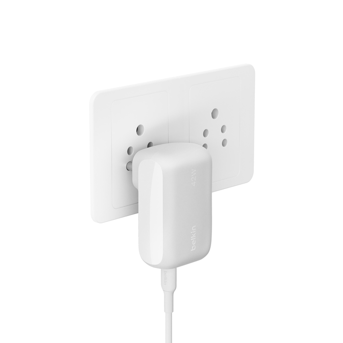 Side view of a Belkin 42W charger plugged into a dual wall socket, showcasing its compact design and sleek finish.